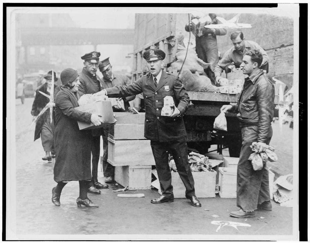 New York World-Telegram and Sun, 1930 — police handing out eggs and bread at the East 104th Street station house