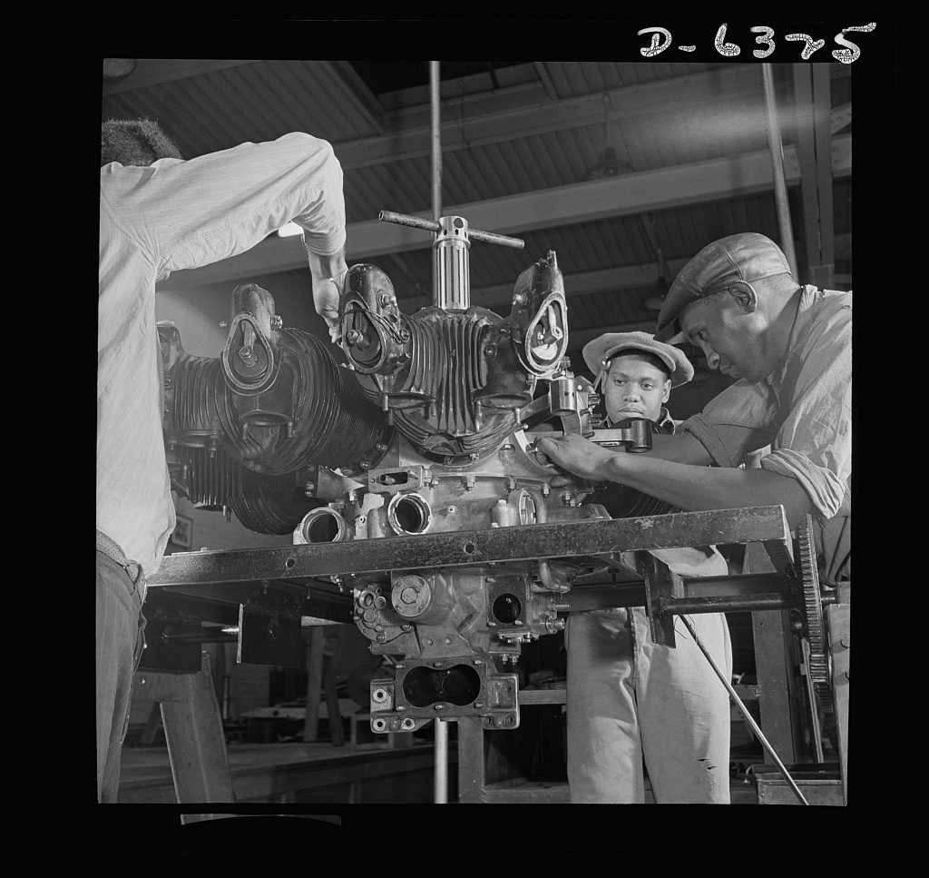 Howard Liberman, OWI, 1942 — three men at a WPA vocational school rebuilding an aircraft engine