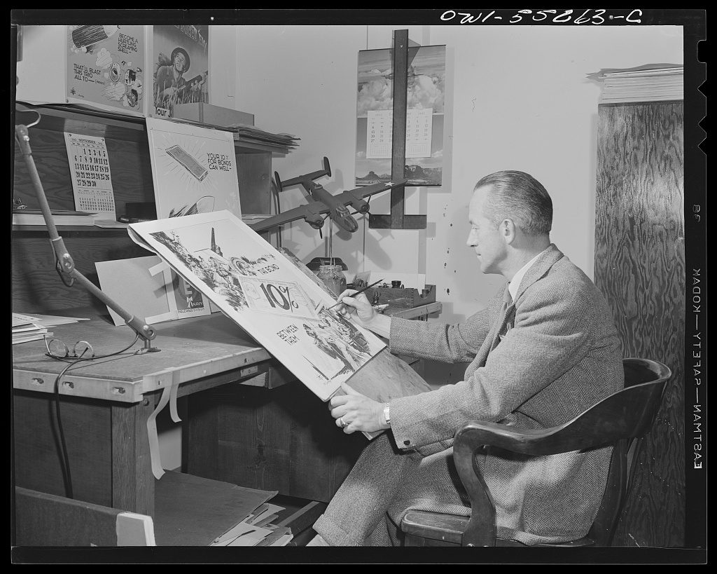 Alfred T. Palmer, Office of War Information, 1942 — a public relations artist at his drafting table painting a war bond poster