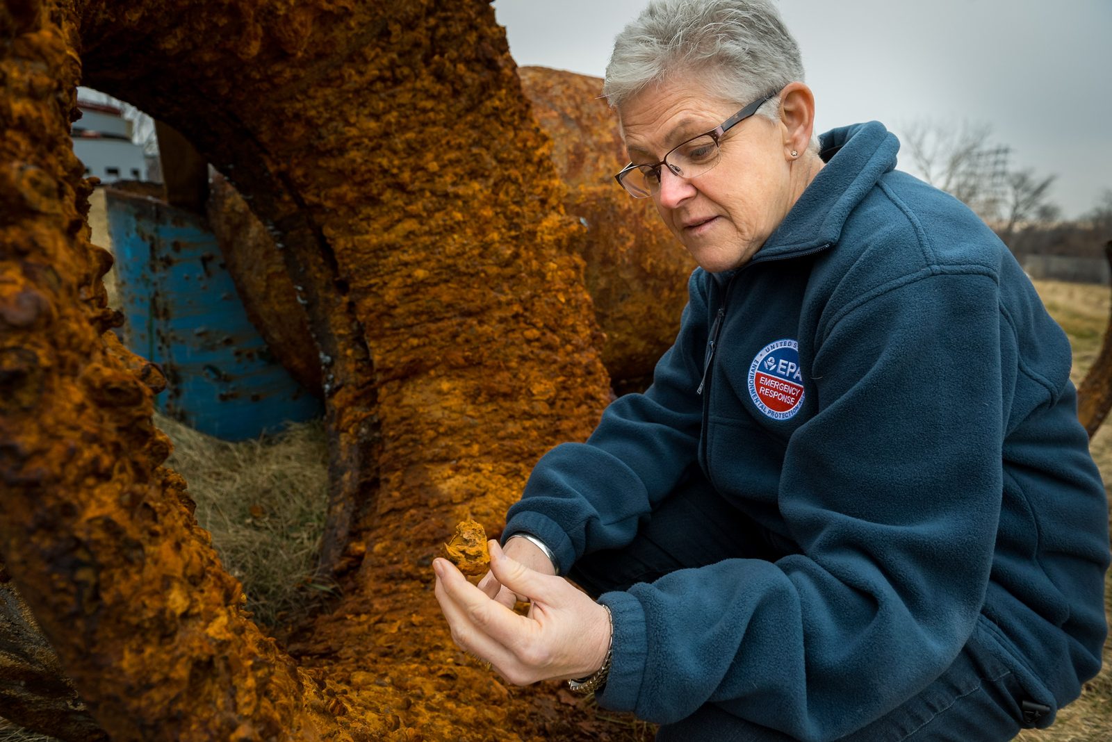 EPA Administrator Gina McCarthy examines corroded pipe scale from Flint water infrastructure, February 2 2016