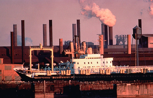 Industrial waterfront with multiple smokestacks, circa 1970s
