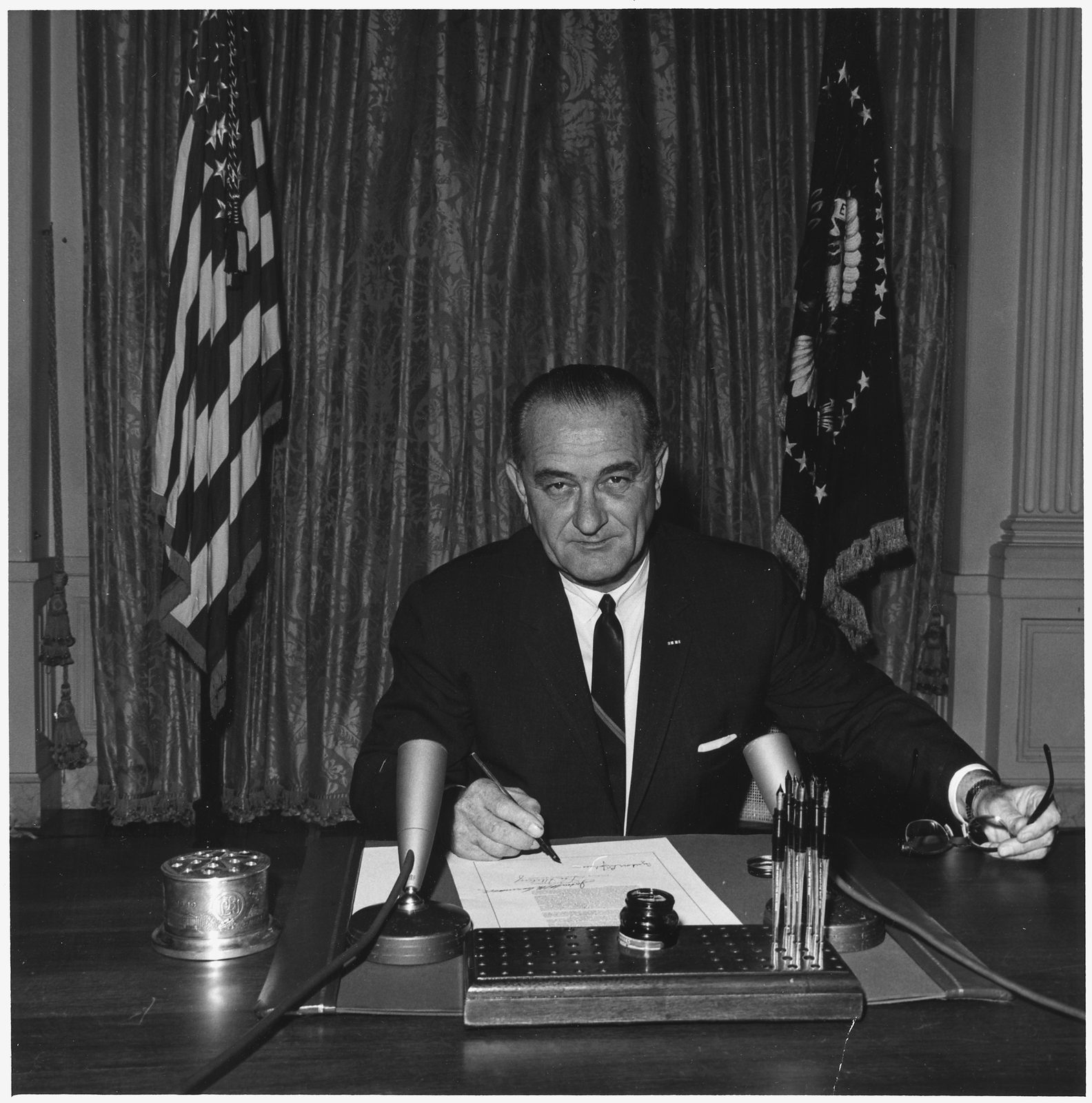 President Lyndon Johnson signs the Gulf of Tonkin Resolution, White House East Room, August 10 1964